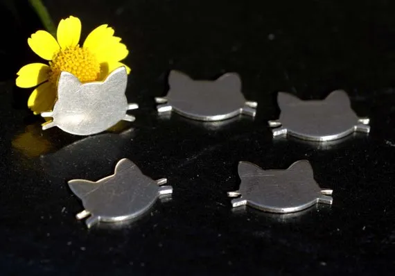 Tiny metal Cat Head blanks